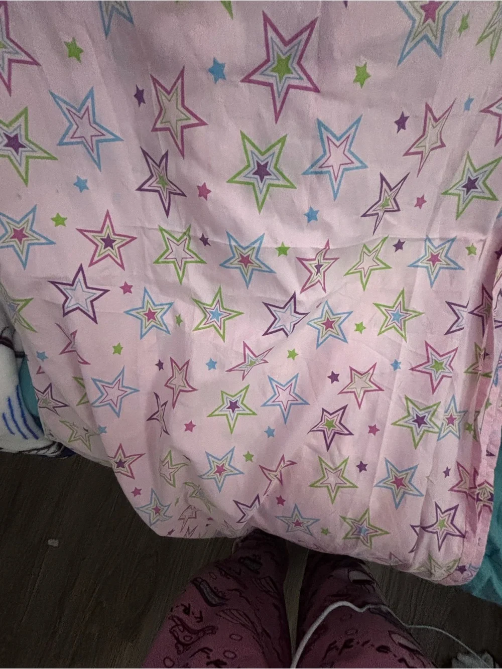 Pink bedsheet with multicolored stars